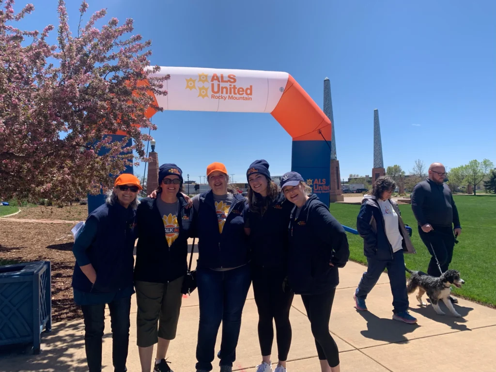 Picture of individuals in front of the ALS United Rocky Mountain Walk Archway